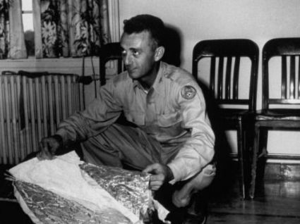 Major Jesse Marcel is believed to have helped clear the wreckage of an alleged alien ship that crashed landed in Roswell, New Mexico, in 1947. Here, Marcel displays the remnants of a weather balloon he claimed was found at a press conference following the incident. 